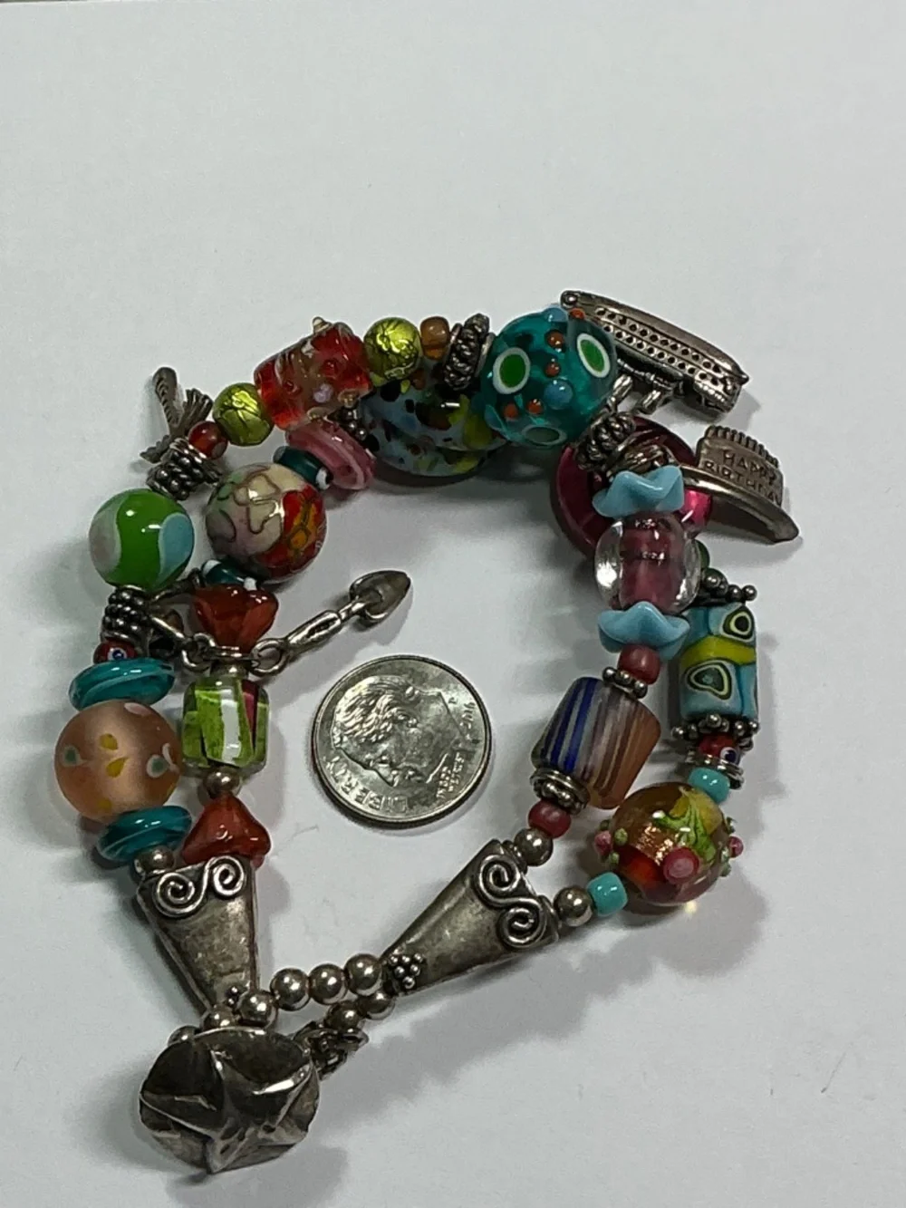 Sterling Silver and Lampwork glass beads W/ 4 Sterling Silver charms. 7.5” long
